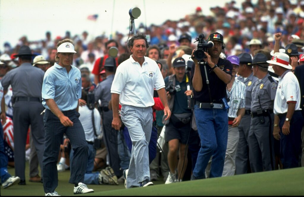 Hale Irwin and Bernhard Langer walking on the fairway together during the final day singles matches of the 1991 Ryder Cup
